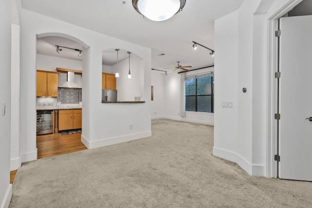 2600 Hillsboro Pike # 233, Nashville, TN 37212 - unfurnished living room with light carpet, a ceiling fan, track lighting, wine cooler, and baseboards