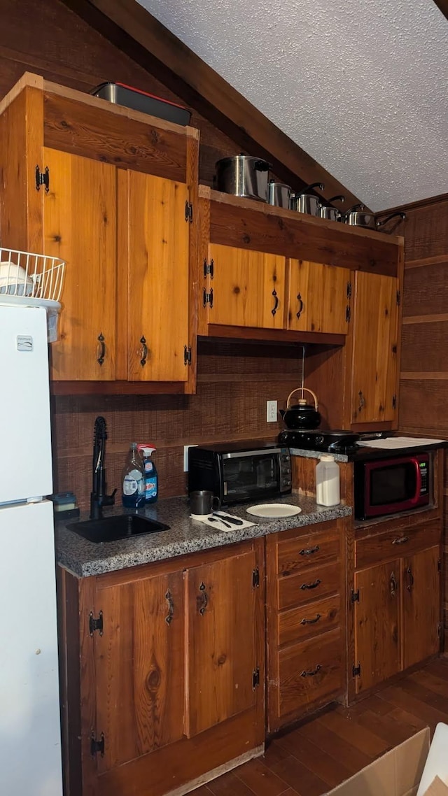 1611 Saltlick Pl, Murfreesboro, TN 37129 - kitchen with freestanding refrigerator, brown cabinets, a sink, tasteful backsplash, and a textured ceiling