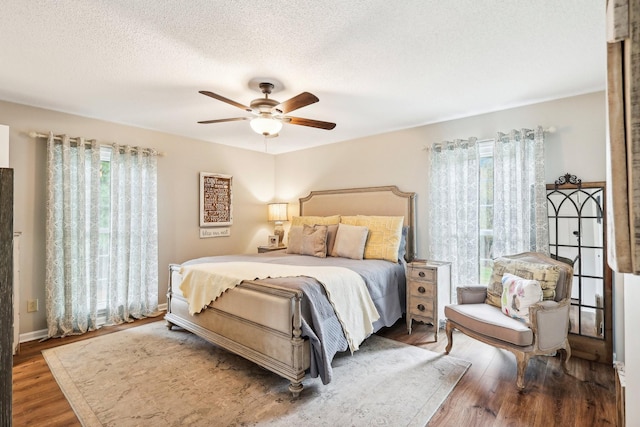 3411 Murphy Ln, Columbia, TN 38401 - bedroom featuring wood finished floors, multiple windows, ceiling fan, a textured ceiling, and baseboards