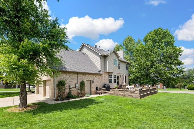 1243 Curtis Dr, Lebanon, TN 37087 - back of house with a lawn, brick siding, driveway, a chimney, and a patio