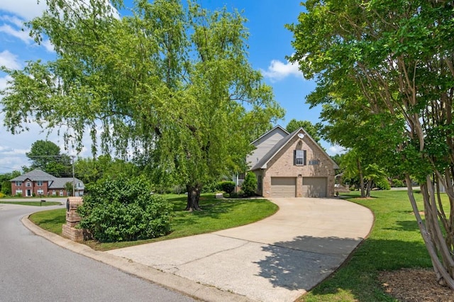 1243 Curtis Dr, Lebanon, TN 37087 - view of front of property featuring a garage, a front yard, driveway, and brick siding