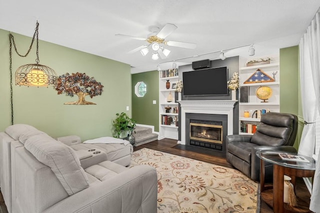1243 Curtis Dr, Lebanon, TN 37087 - living room with a ceiling fan, dark wood finished floors, a fireplace with flush hearth, built in shelves, and baseboards