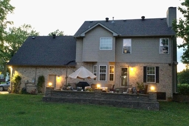 1243 Curtis Dr, Lebanon, TN 37087 - back of house featuring a chimney, a lawn, and brick siding