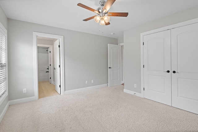 1005 Brittain Downs Dr, Nolensville, TN 37135 - unfurnished bedroom featuring light colored carpet, a closet, baseboards, ensuite bath, and a ceiling fan