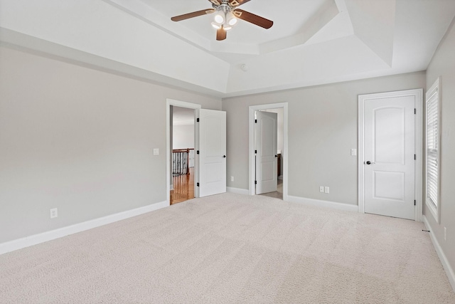 1005 Brittain Downs Dr, Nolensville, TN 37135 - unfurnished bedroom featuring a tray ceiling, carpet flooring, baseboards, and a ceiling fan