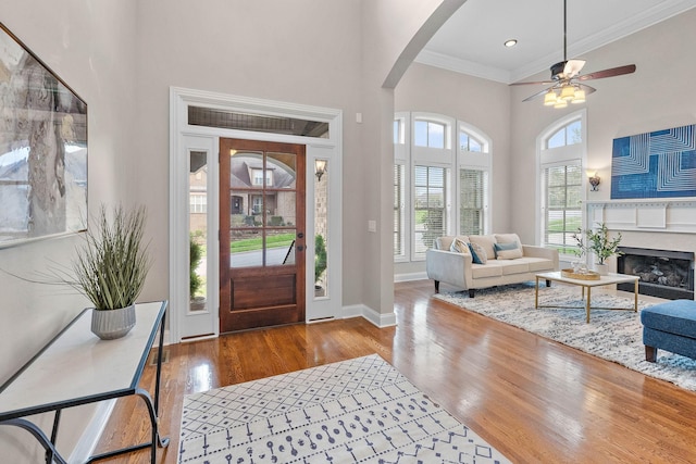 1005 Brittain Downs Dr, Nolensville, TN 37135 - foyer entrance featuring a high ceiling, arched walkways, crown molding, wood finished floors, and a ceiling fan