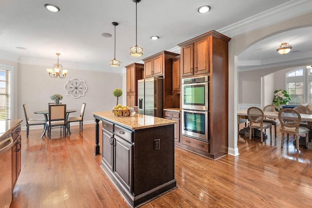 1005 Brittain Downs Dr, Nolensville, TN 37135 - kitchen featuring stainless steel appliances, ornamental molding, arched walkways, a chandelier, and a center island