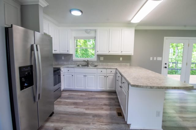 5538 Lexie Beans Creek Rd, Belvidere, TN 37306 - kitchen featuring stainless steel fridge, a peninsula, a sink, light countertops, and ornamental molding