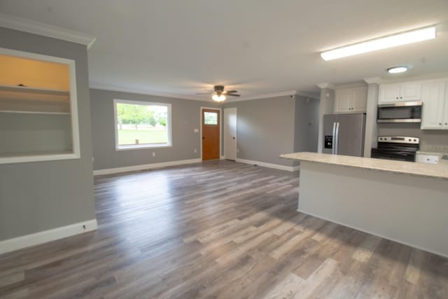 5538 Lexie Beans Creek Rd, Belvidere, TN 37306 - kitchen with appliances with stainless steel finishes, crown molding, white cabinetry, baseboards, and a ceiling fan