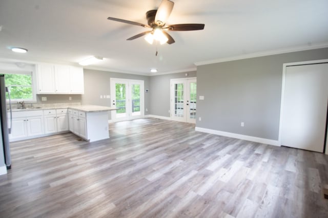 5538 Lexie Beans Creek Rd, Belvidere, TN 37306 - kitchen with french doors, a peninsula, ornamental molding, light countertops, and ceiling fan