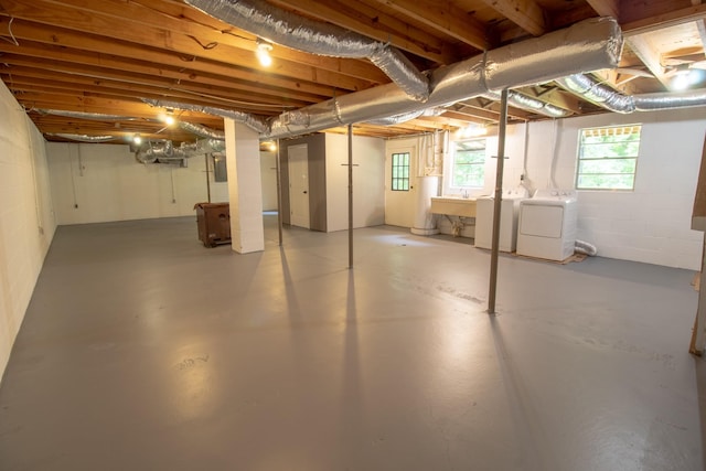 5538 Lexie Beans Creek Rd, Belvidere, TN 37306 - below grade area featuring washing machine and clothes dryer, a sink, and healthy amount of natural light
