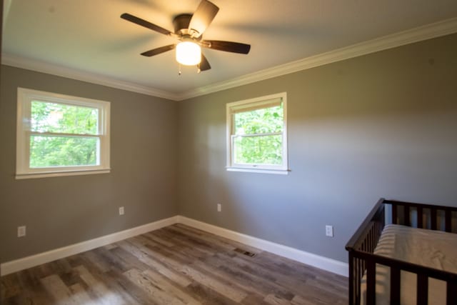 5538 Lexie Beans Creek Rd, Belvidere, TN 37306 - unfurnished bedroom featuring wood finished floors, ornamental molding, baseboards, and a ceiling fan