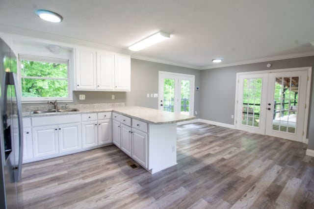 5538 Lexie Beans Creek Rd, Belvidere, TN 37306 - kitchen with french doors, a sink, a peninsula, crown molding, and stainless steel fridge with ice dispenser