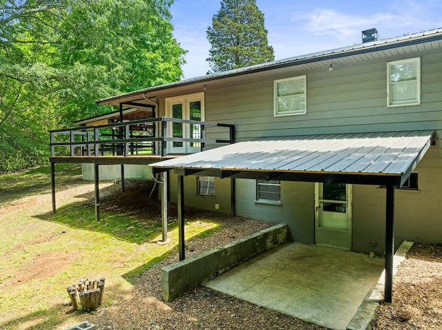 5538 Lexie Beans Creek Rd, Belvidere, TN 37306 - rear view of house with a deck, metal roof, and a patio area