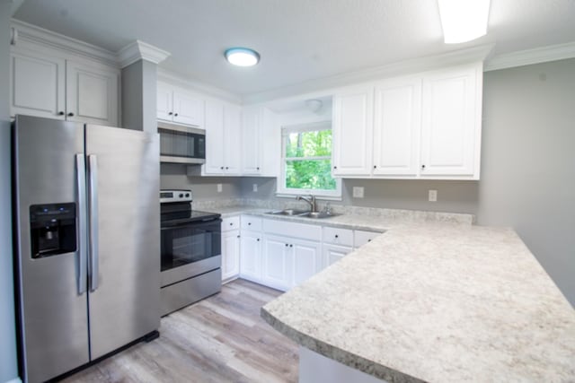 5538 Lexie Beans Creek Rd, Belvidere, TN 37306 - kitchen featuring appliances with stainless steel finishes, a sink, light wood finished floors, light countertops, and ornamental molding