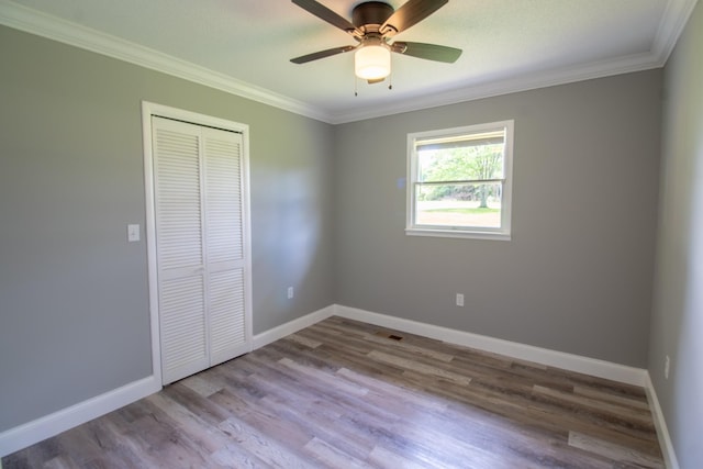 5538 Lexie Beans Creek Rd, Belvidere, TN 37306 - unfurnished bedroom with a closet, ornamental molding, wood finished floors, baseboards, and ceiling fan