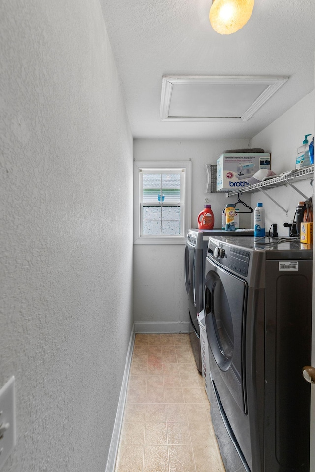 917 Lavergne Ln, La Vergne, TN 37086 - washroom featuring independent washer and dryer, baseboards, a textured wall, and light tile patterned flooring