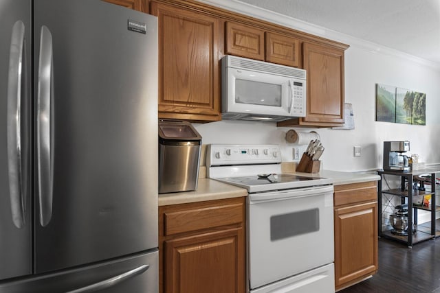 917 Lavergne Ln, La Vergne, TN 37086 - kitchen with white appliances, ornamental molding, brown cabinets, light countertops, and dark wood-type flooring