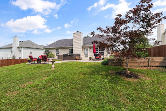 917 Lavergne Ln, La Vergne, TN 37086 - back of property featuring a hot tub, a patio area, and a chimney