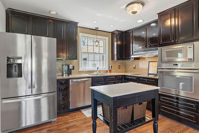 1899 Berrys Chapel Ct, Franklin, TN 37069 - kitchen with appliances with stainless steel finishes, under cabinet range hood, a sink, backsplash, and recessed lighting