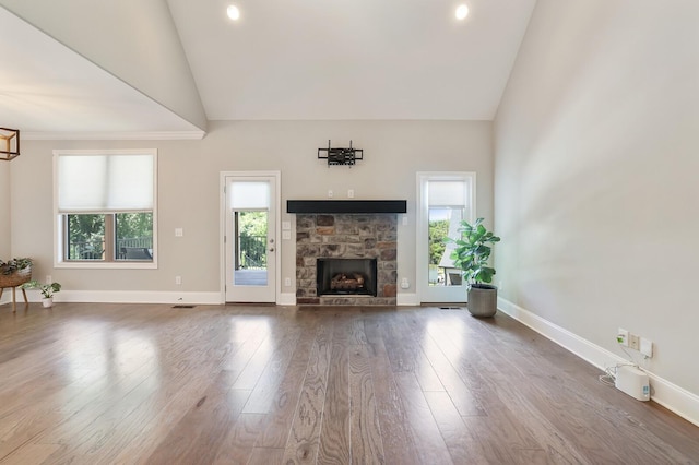 212 Lotus Ct, Hendersonville, TN 37075 - unfurnished living room with high vaulted ceiling, a stone fireplace, wood finished floors, baseboards, and recessed lighting