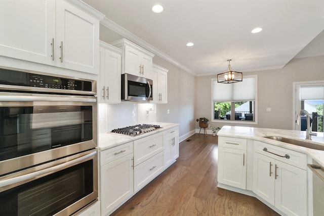 212 Lotus Ct, Hendersonville, TN 37075 - kitchen featuring stainless steel appliances, a sink, white cabinets, wood finished floors, and recessed lighting