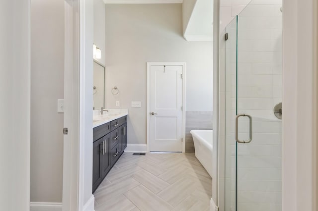 212 Lotus Ct, Hendersonville, TN 37075 - bathroom featuring double vanity, a freestanding bath, a stall shower, and baseboards