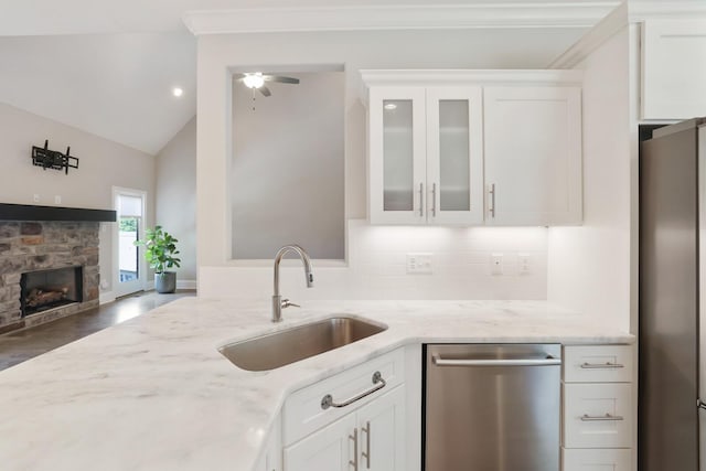 212 Lotus Ct, Hendersonville, TN 37075 - kitchen with stainless steel appliances, a sink, light stone countertops, glass insert cabinets, and white cabinetry