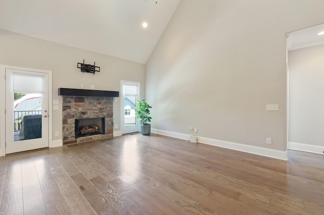 212 Lotus Ct, Hendersonville, TN 37075 - unfurnished living room with wood finished floors, plenty of natural light, a fireplace, high vaulted ceiling, and recessed lighting
