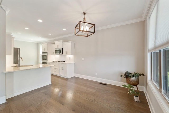 212 Lotus Ct, Hendersonville, TN 37075 - kitchen with a sink, stainless steel appliances, ornamental molding, a chandelier, and white cabinets