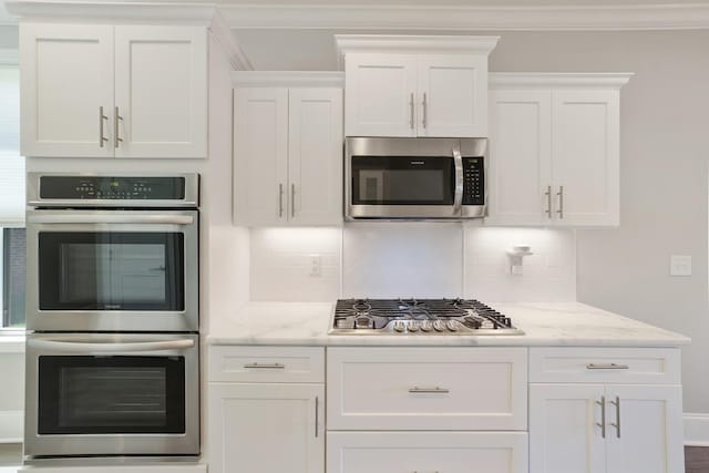 212 Lotus Ct, Hendersonville, TN 37075 - kitchen featuring stainless steel appliances, white cabinetry, crown molding, tasteful backsplash, and light stone counters