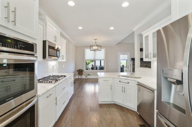 212 Lotus Ct, Hendersonville, TN 37075 - kitchen with appliances with stainless steel finishes, a sink, white cabinetry, wood finished floors, and recessed lighting