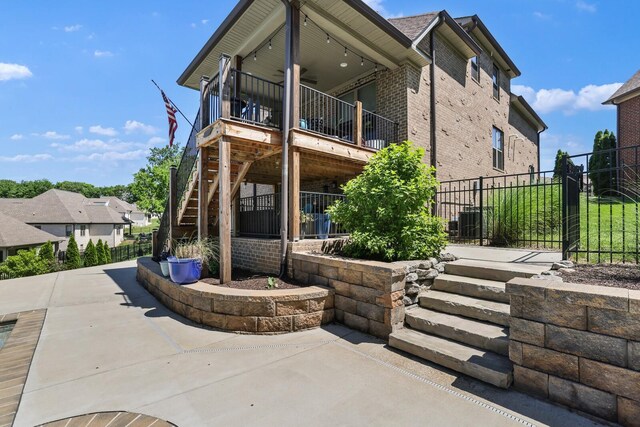 212 Lotus Ct, Hendersonville, TN 37075 - rear view of house with stairway, a ceiling fan, a patio, and brick siding