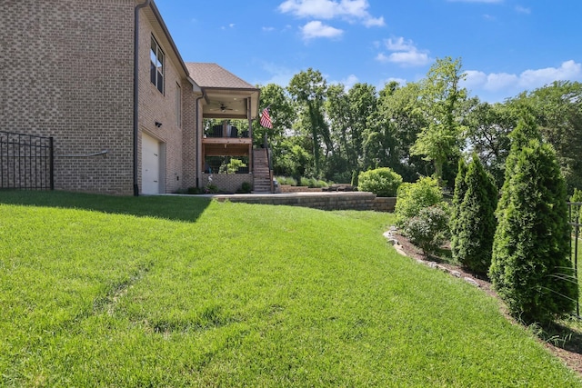 212 Lotus Ct, Hendersonville, TN 37075 - view of grassy yard with stairway, a ceiling fan, and an attached garage