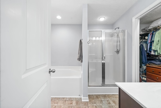 4115 Giacomo Dr, Murfreesboro, TN 37128 - bathroom with a stall shower, a bath, a walk in closet, vanity, and a textured ceiling