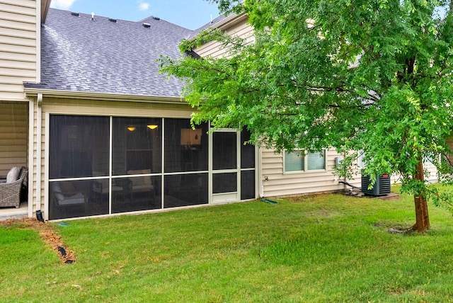 4115 Giacomo Dr, Murfreesboro, TN 37128 - back of property featuring a shingled roof, a lawn, a sunroom, and central AC unit