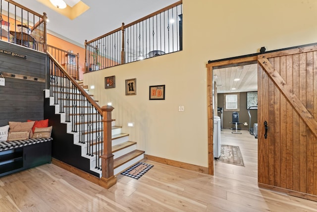 860 Old Woodbury Pike, Readyville, TN 37149 - stairway featuring wood finished floors, baseboards, a barn door, and a high ceiling
