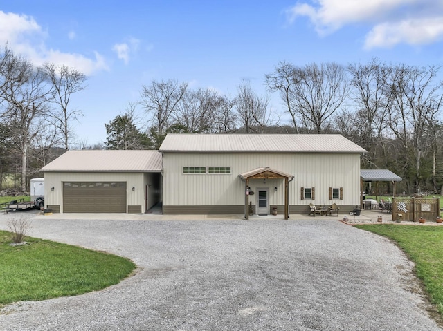 860 Old Woodbury Pike, Readyville, TN 37149 - view of front of house with driveway, metal roof, and a garage