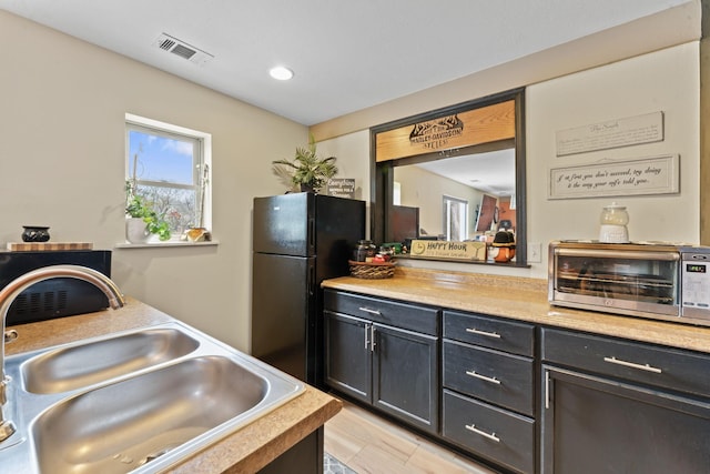 860 Old Woodbury Pike, Readyville, TN 37149 - kitchen with a sink, light countertops, freestanding refrigerator, and recessed lighting