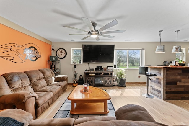 860 Old Woodbury Pike, Readyville, TN 37149 - living area with light wood-style floors, a ceiling fan, baseboards, and a dry bar