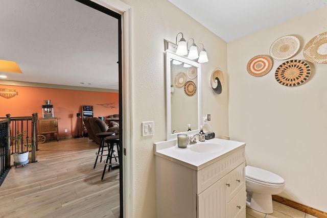 860 Old Woodbury Pike, Readyville, TN 37149 - bathroom featuring vanity, toilet, wood finished floors, and baseboards