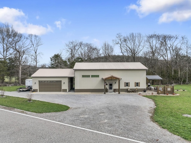 860 Old Woodbury Pike, Readyville, TN 37149 - view of front of property with gravel driveway, metal roof, a front lawn, and an attached garage