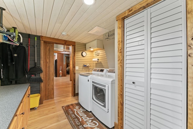 860 Old Woodbury Pike, Readyville, TN 37149 - laundry area with washer and dryer, wood walls, light wood-style floors, wooden ceiling, and cabinet space