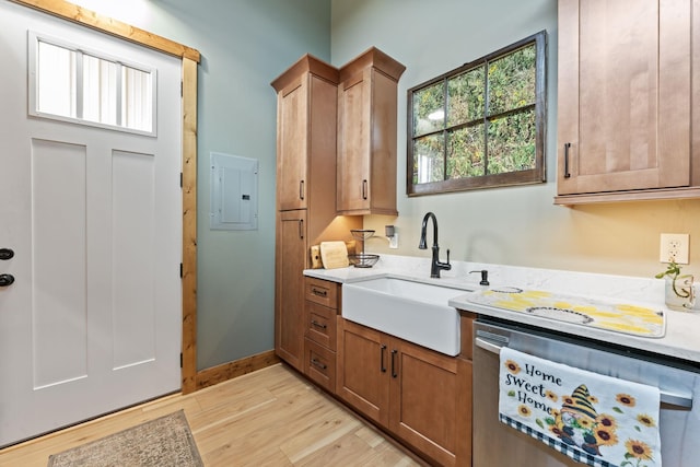 860 Old Woodbury Pike, Readyville, TN 37149 - kitchen with stainless steel dishwasher, a sink, electric panel, light countertops, and light wood-style flooring