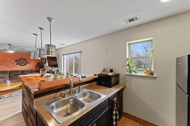 860 Old Woodbury Pike, Readyville, TN 37149 - kitchen with freestanding refrigerator, black microwave, a sink, open floor plan, and ceiling fan