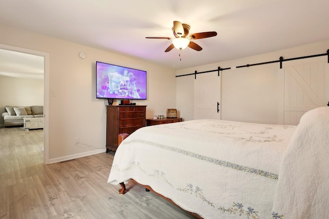 1864 Sawgrass Ln, Chapel Hill, TN 37034 - bedroom featuring a barn door, light wood-style flooring, baseboards, and ceiling fan