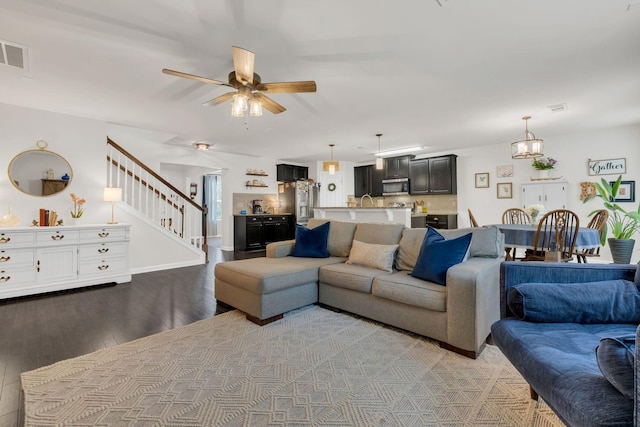 1464 Old Stone Rd, Lebanon, TN 37087 - living area with wood finished floors, stairs, ceiling fan, and a chandelier