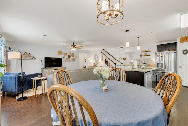 1464 Old Stone Rd, Lebanon, TN 37087 - dining space featuring dark wood-style flooring, ceiling fan, stairs, and a chandelier