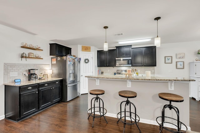 1464 Old Stone Rd, Lebanon, TN 37087 - kitchen with appliances with stainless steel finishes, tasteful backsplash, dark cabinetry, and dark wood-style floors