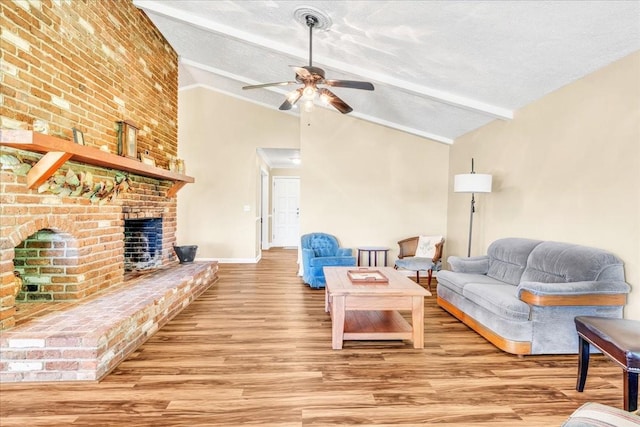183 Prairie Plains Rd, Hillsboro, TN 37342 - living area with a ceiling fan, wood finished floors, a brick fireplace, baseboards, and a textured ceiling